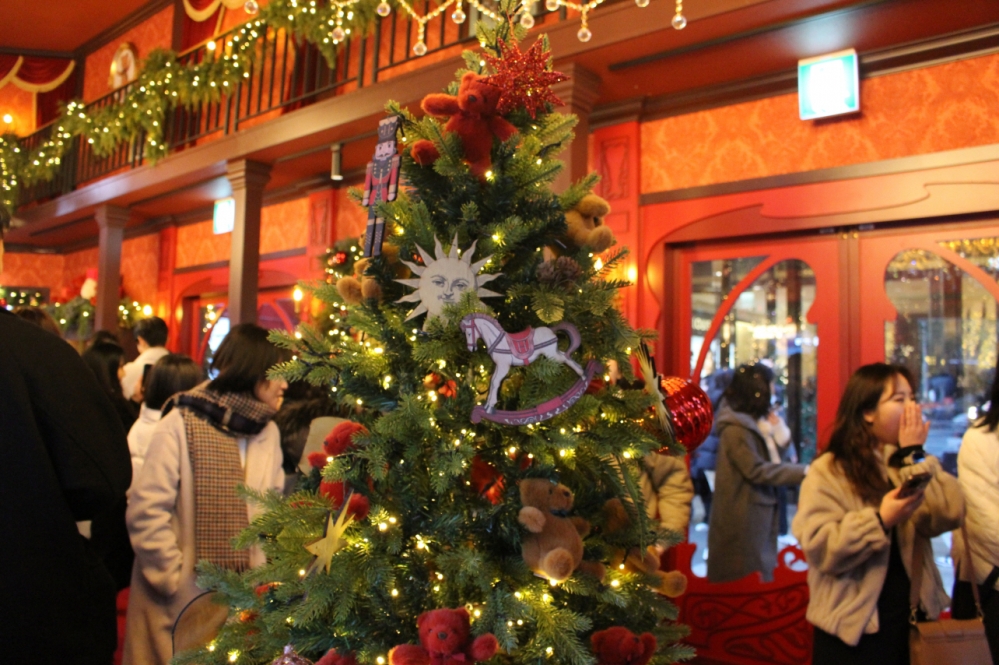 사진 설명 시작. 백화점 팝업스토어 내부가 사람들로 인산인해를 이뤘다. 가운데에 곰인형, 별, 목마 등 장식품이 달린 크리스마스트리가 서있다. 사진 설명 끝.