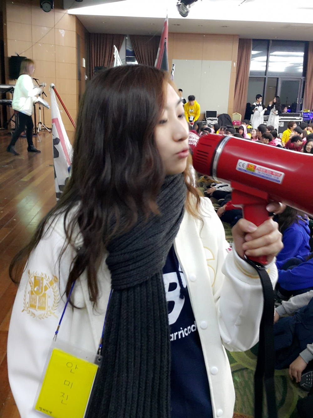 사진 설명 시작. 강당 안에서 확성기를 들고 무언가를 설명하고 있는 여성의 모습. ▲2학년 시절 새맞이장으로 활동하던 안미진 씨다. 사진 설명 끝.